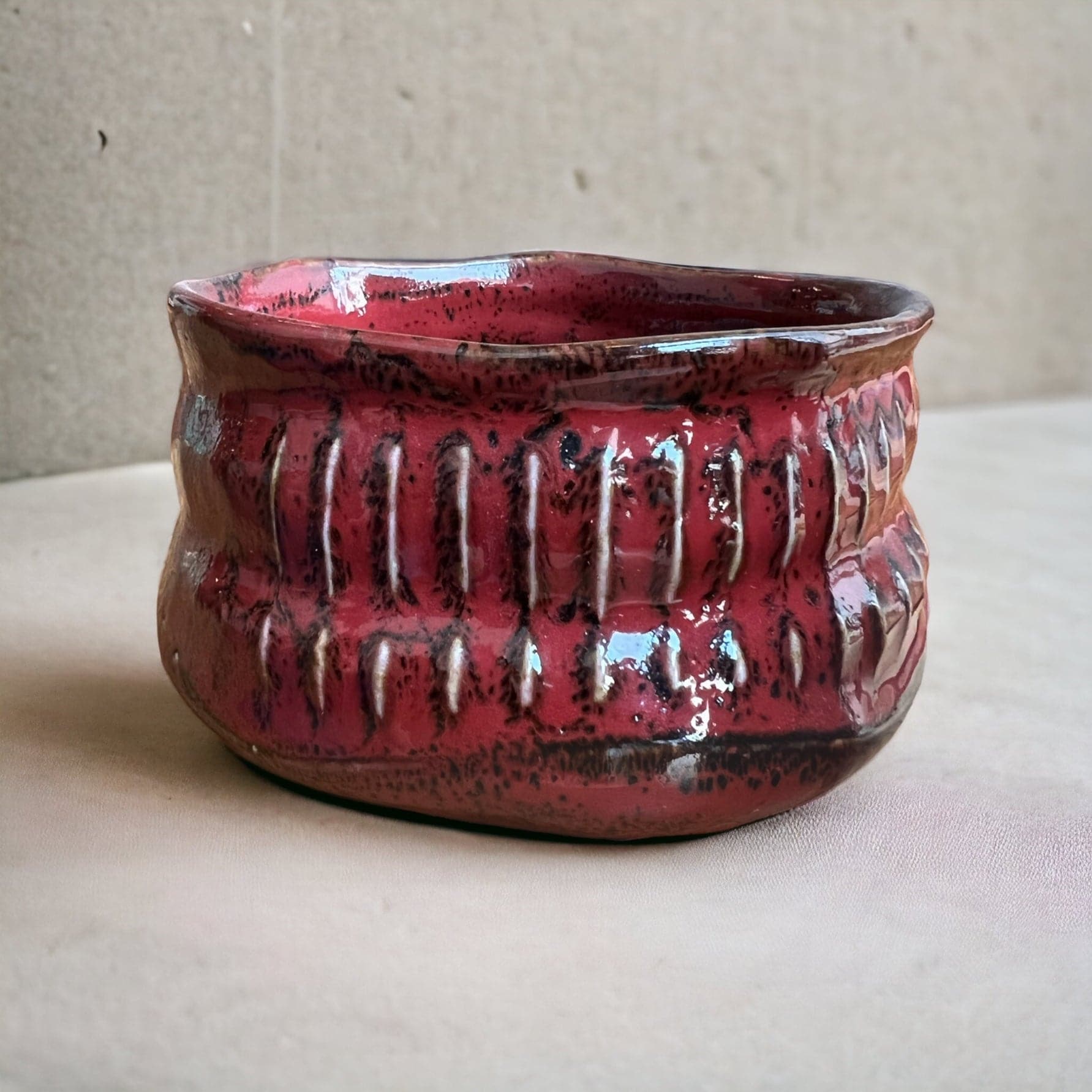 Side shot of the texturized red matcha bowl.