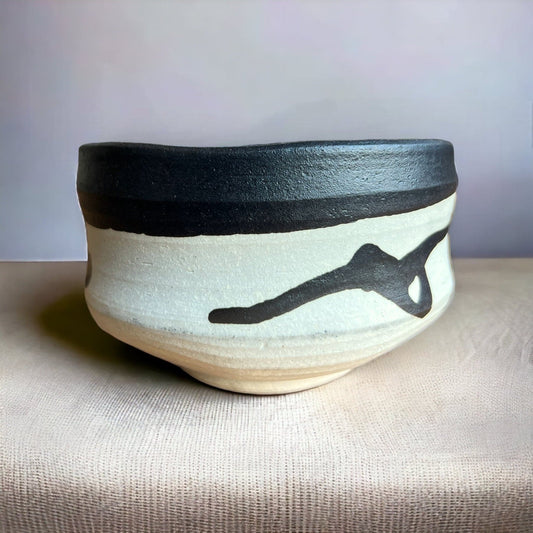 One side of the Hand Made Ink Spot Matcha Bowl.